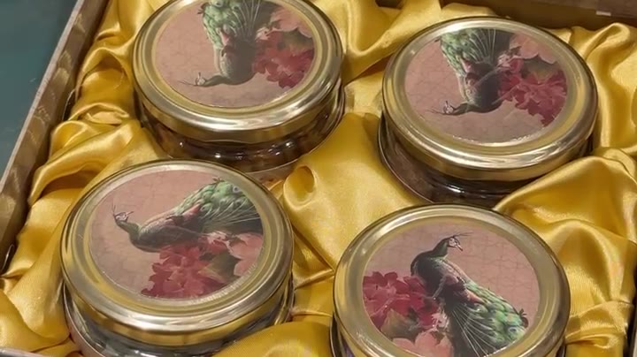 Green Peacock gift box with four glass jars on gold satin